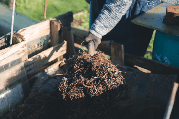 A man digging in a homemade worm bin