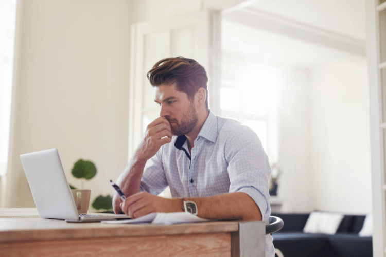 a side view of a man working on laptop